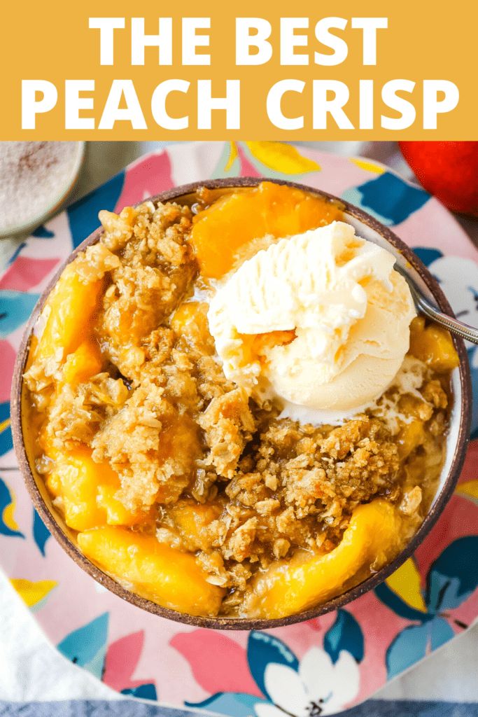 the best peach crisp in a bowl with ice cream on top