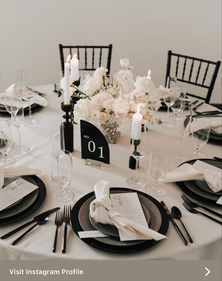 the table is set with black and white place settings