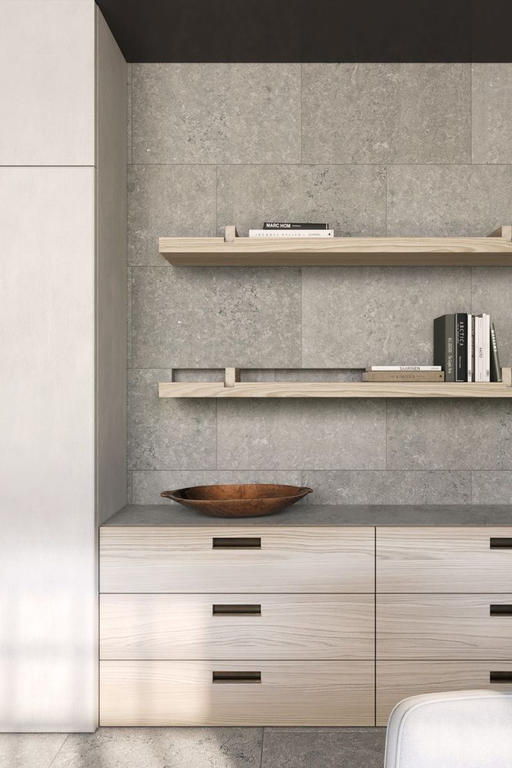 an empty room with shelves and a bowl on the counter top in front of it