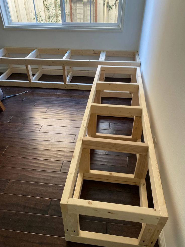 a room with wood flooring and built in benches