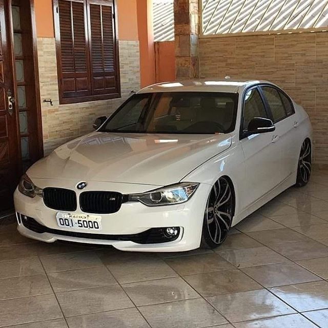 a white car is parked in a garage