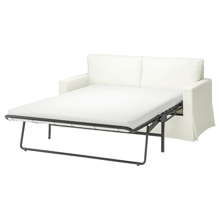 a white couch with a pull out bed on it's backrest and arm rest