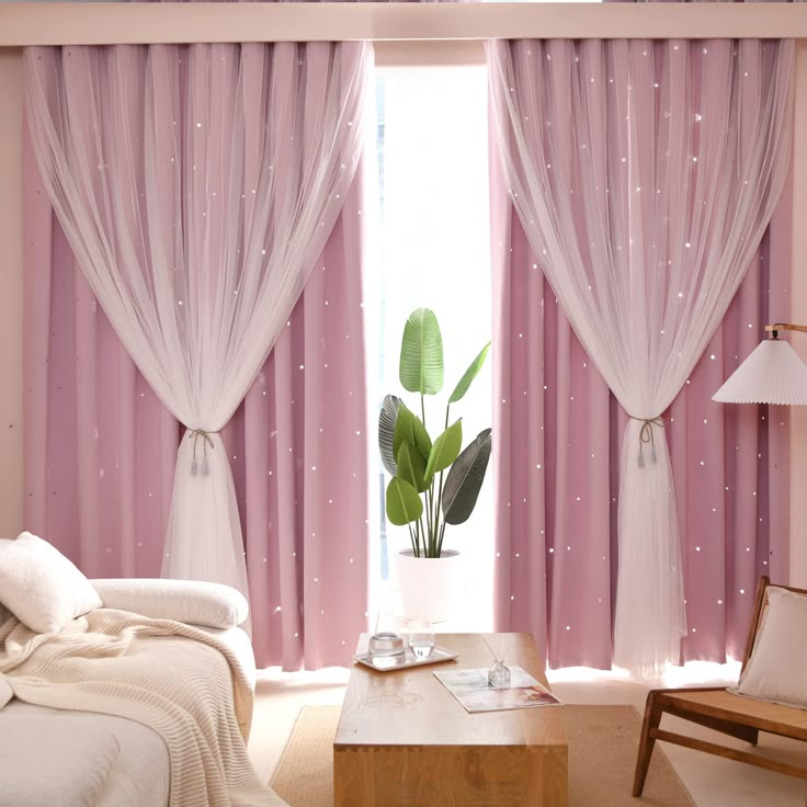 a bedroom with pink curtains and white bedding