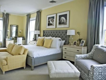 a bedroom with yellow walls and white furniture