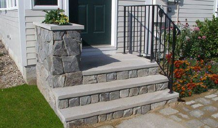 a house with stone steps leading up to the front door