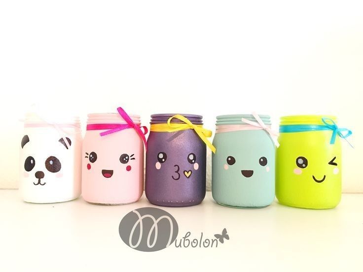 five painted mason jars with different faces on them and ribbons tied around the lids, lined up in a row