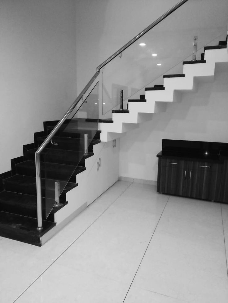 a black and white photo of a stair case in a room with tile flooring