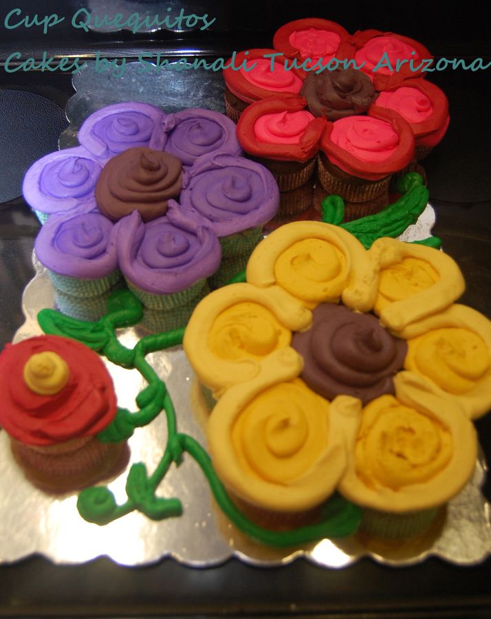 cupcakes decorated with colorful icing and flowers