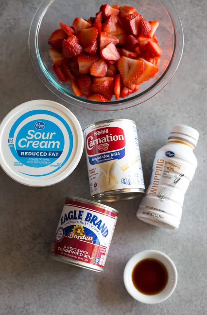 the ingredients to make strawberry shortcakes are displayed in bowls