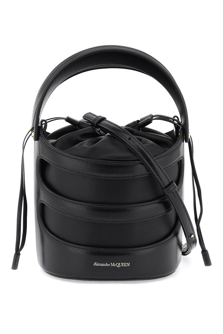 The Rise bucket bag by Alexander McQueen is made of leather with a structured Harness-style cage and a soft nappa pouch. It features a drawstring closure, a leather interior, and an adjustable and removable shoulder strap. The metallic accessories have a gold finish. Harness Style, Metallic Accessories, Metal Accessories, Leather Bucket Bag, Leather Bucket, The Rise, Leather Interior, Leather Fashion, Gold Finish