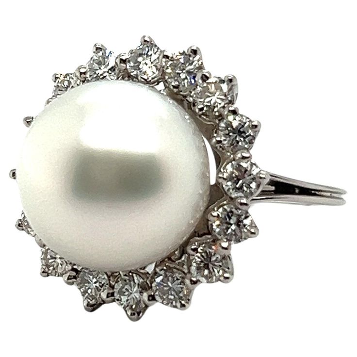 Elevate your elegance with our stunning pearl ring. Designed in 18 Karat white gold, it features a radiant South Sea cultural pearl at its heart, exuding natural charm. Encircled by a halo of 16 brilliant-cut diamonds totaling 0.96 carats, shimmering with G-H colour and vs clarity, this ring sparkles with every movement. It is commonly known, that pearls are renowned for their calming energy, believed to promote balance and harmony. Embrace the sophistication of pearls and diamonds in this perfect union of luxury and serenity. 16 diamonds, G-H/vs, brilliant cut, tot. 0.96 ct. 1 South Sea cultural pearl Weight: 9.85 gr. Size: 50 EU / 5.25 US Luxury White Pearl Ring With Halo, Fine Pearl Jewelry, European Modern, Sparkling Rings, Pearl Diamond, Pearl Ring, Brilliant Cut Diamond, Cocktail Rings, Pearl Jewelry