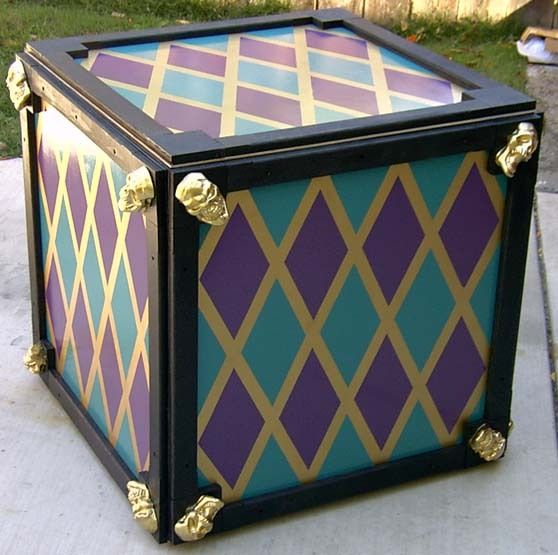 a colorful box sitting on top of a sidewalk