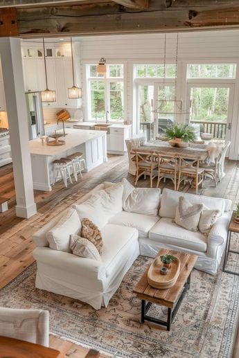 a living room filled with furniture next to a kitchen