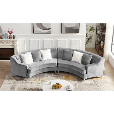 a large sectional couch with pillows on it