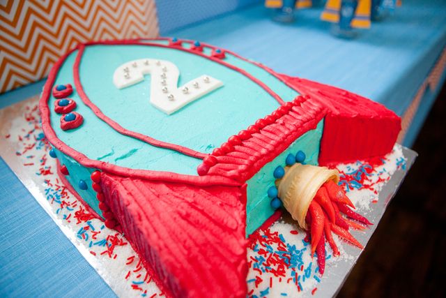 a blue and red birthday cake on a table