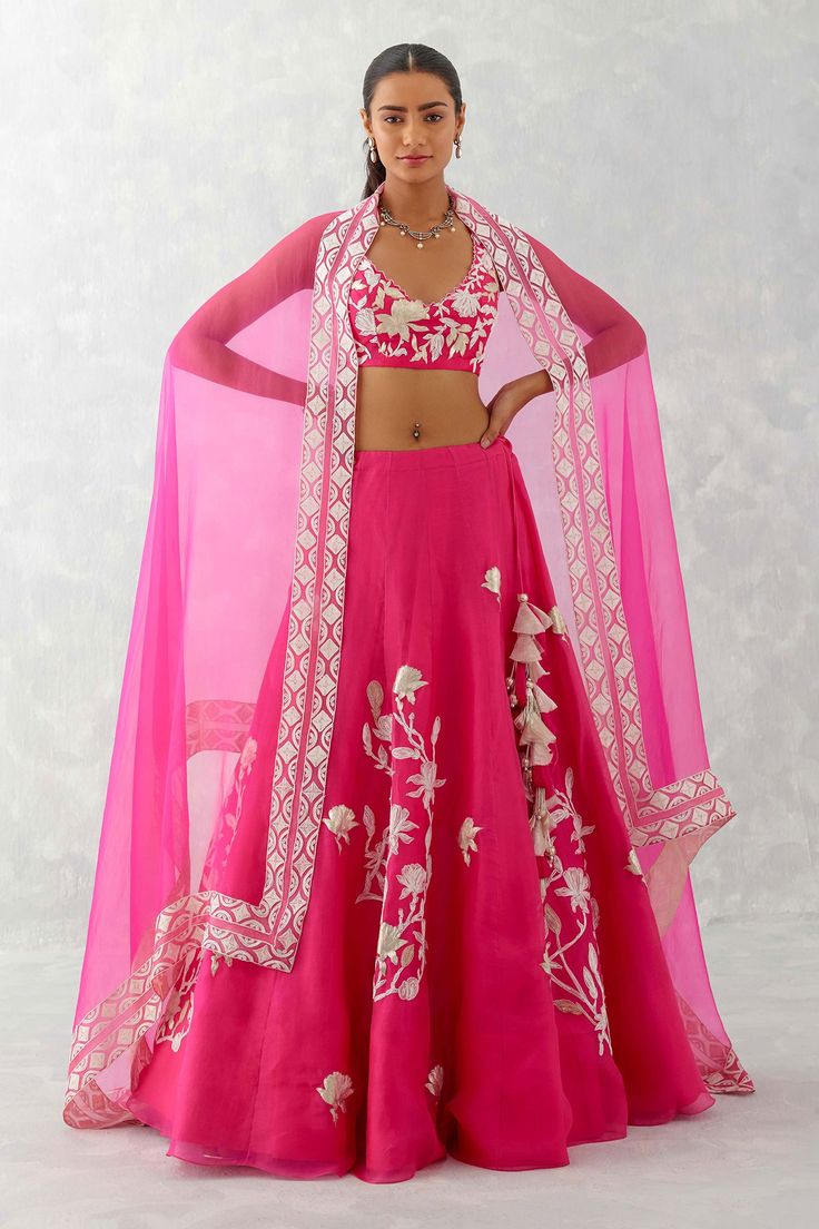 Fuchsia lehenga with white thread embroidered floral and leaf motifs. Comes with sleeveless embroidered blouse and sheer dupatta. Components: 3 Pattern: Embroidery Type Of Work: Thread Neckline: V neck Sleeve Type: Sleeveless Fabric: Silk Organza Color: Fuchsia Other Details:  Blouse with cutwork detail at the neckline Sheer dupatta with embroidered border Closure: Blouse: Back hook Lehenga: Side zip and tie up Occasion: Sangeet - Aza Fashions Fuchsia Lehenga, Sheer Dupatta, Organza Embroidery, Organza Lehenga, Couple Wedding Dress, Blouse Measurement, Pink Lehenga, Lehenga Blouse, Embroidered Border