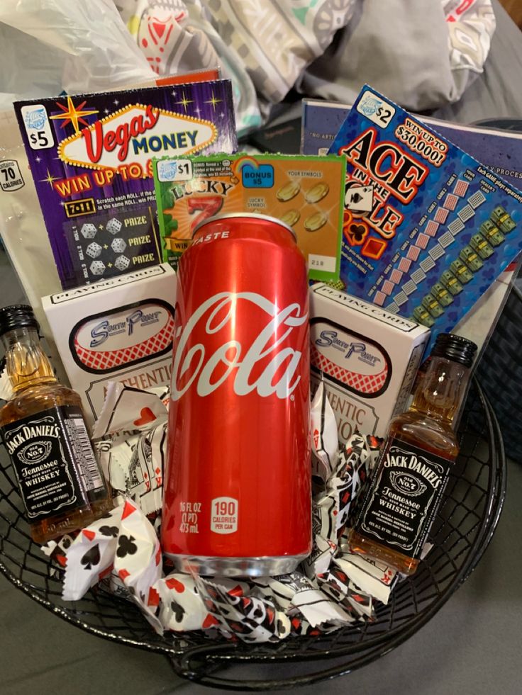 a soda can sitting on top of a basket filled with snacks and condiments