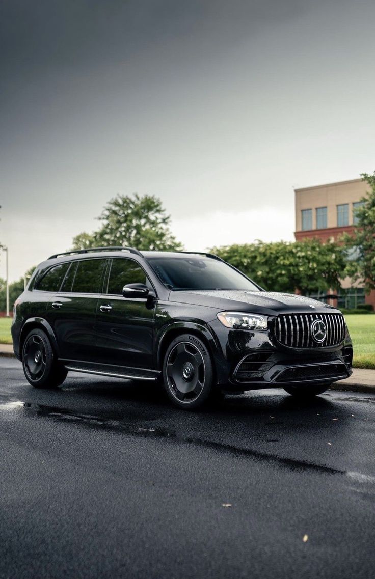 a black mercedes gle is parked on the side of the road