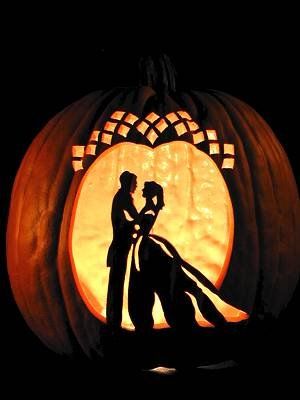 a carved pumpkin with a silhouette of a bride and groom