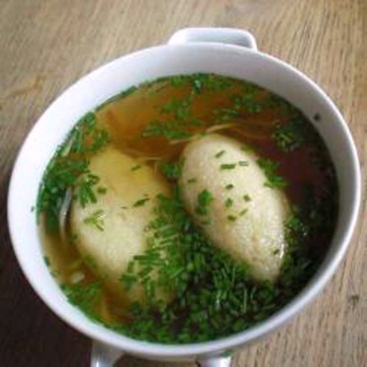 two pieces of fish in broth and some parsley on top of the soup