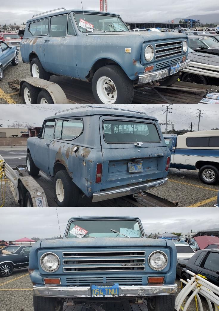 an old blue truck parked in a parking lot next to other cars and trucks with the same paint job