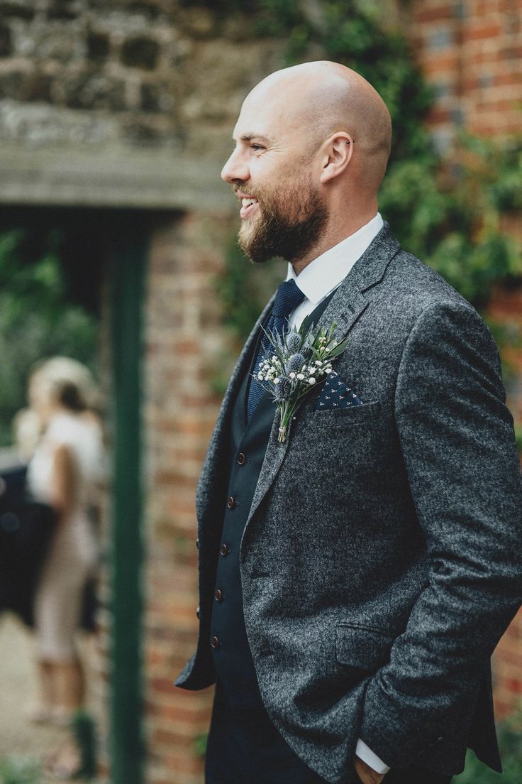 a man in a suit and tie standing outside