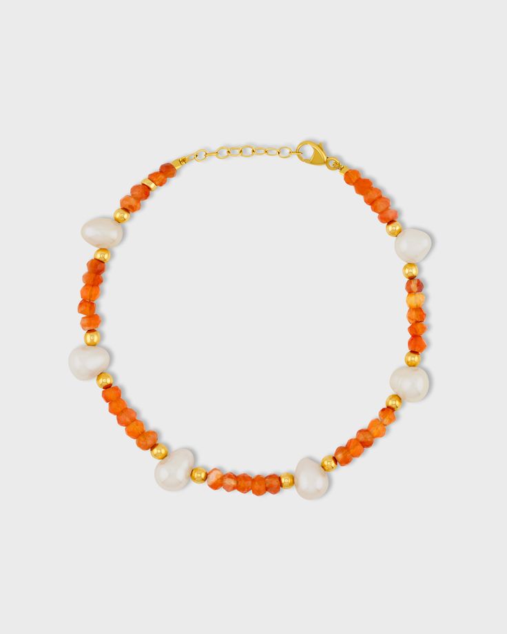 Fiery orange carnelian crystals hand strung with freshwater pearls throughout in our native New York City. This bracelet is finished with 14 karat gold. Carnelian, Pearl 14 Karat yellow gold 6 to 7 inches length 3.5mm to 7.5mm bead size Style # JJ-BAZ-125 UPC 810109745357 Orange Carnelian Beaded Bracelet With Gemstone, Orange Carnelian Gemstone Beaded Bracelets, Orange Carnelian Gemstone Beaded Bracelet, Orange Agate Gemstone Bracelets, Orange Hand-strung Carnelian Bracelets, Orange Carnelian Hand-strung Bracelets, Orange Carnelian Gemstone Bead Bracelets, Orange Carnelian Bracelets With Natural Stones, Orange Gemstone Beaded Bracelets With Round Beads