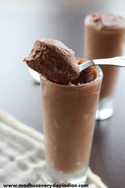 two glasses filled with chocolate pudding and ice cream