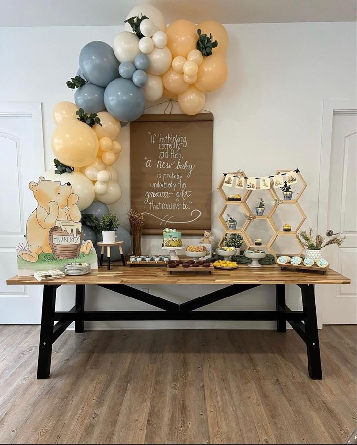 a table with balloons and desserts on it