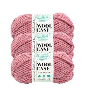 three skeins of wool ease yarn in pink