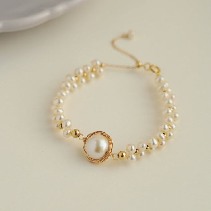 Discover the elegance and beauty of our Coco Kim Classic Wrapped Series Stargazer Pearl Bracelet. Handcrafted with care and attention to detail, this stunning bracelet features a classic wrapped design and luminous pearls that will add a touch of sophistication to any outfit. Elevate your style and make a statement with this must-have accessory. Metal: 14k Gold Filled Pearl: Freshwater Pearls Main Pearl Diameter: 13-15mm (including metal parts) Chain Length: 150mm + 50mm adjustable chain Elegant Adjustable Bracelet With Pearl Pendant, Elegant Adjustable Bracelets With Pearl Pendant, Adjustable Pearl Bracelet With Pearl Pendant, Adjustable Pearl Bracelets With Pearl Pendant, Adjustable Bracelet With Pearl Pendant, Pearl White Bracelets With Pearl Pendant For Weddings, Gold Pearl Bracelet With Pearl Pendant, Gold Pearl Bracelet With Round Beads And Pendant, Akoya Pearl Bracelet As A Gift