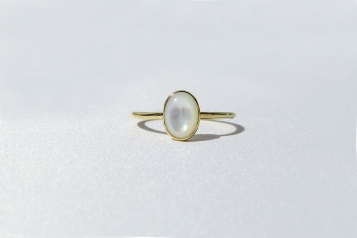 Elegant, simple and truly a classic piece. This mother of pearl ring is made from 14k solid gold or 14k solid white gold material. Set with a natural mother of pearl stone. Each pearl is unique and natural. Whether you're buying this beautiful pearl ring as a gift or for yourself, it will bring forth new beginnings and good luck. Handmade in Los Angeles, CA! Fast Shipping: It will take 1-3 business days to send out your item Packaging: Comes in an upgraded gift box, ready for gift-giving! Pearl Classic White Opal Ring With Polished Finish, 14k Gold Moonstone Ring For Wedding, 14k Gold Polished Moonstone Wedding Ring, 14k Gold Moonstone Ring With Polished Finish For Wedding, Elegant Moonstone Rings With Polished Finish, Timeless Yellow Gold Moonstone Ring, Yellow Gold Polished Moonstone Ring For Wedding, Yellow Gold Moonstone Ring With Polished Finish For Wedding, White Sterling Silver Pearl Ring With Polished Finish