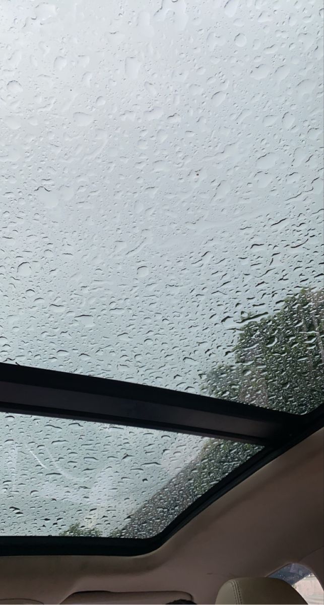 the windshield of a car with rain drops on it