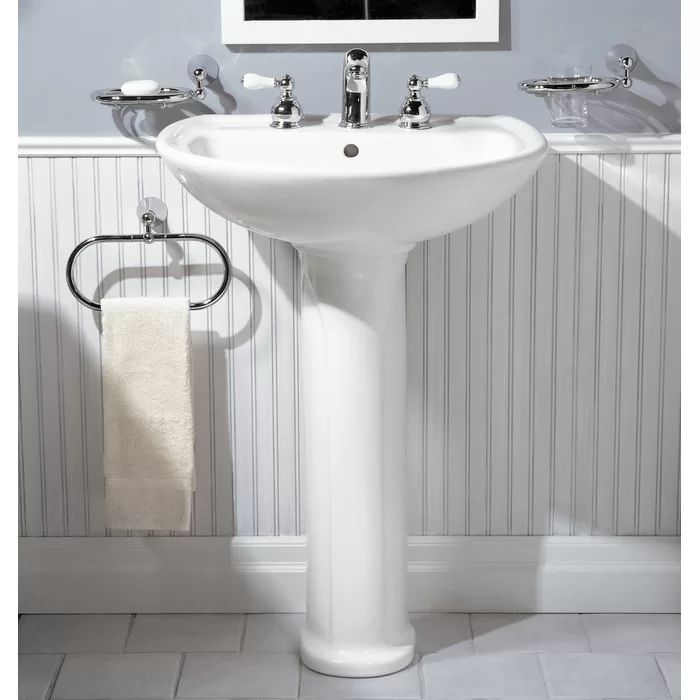 a white pedestal sink sitting under a mirror