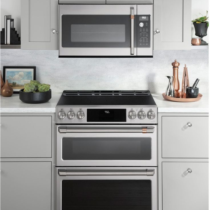 a stainless steel stove and microwave in a kitchen