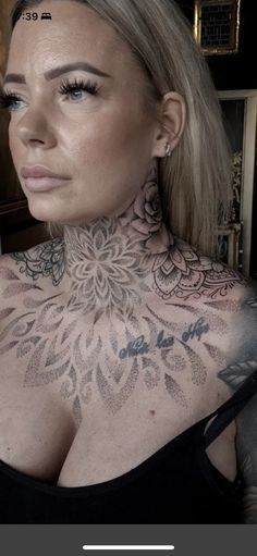 a woman with tattoos on her neck and chest