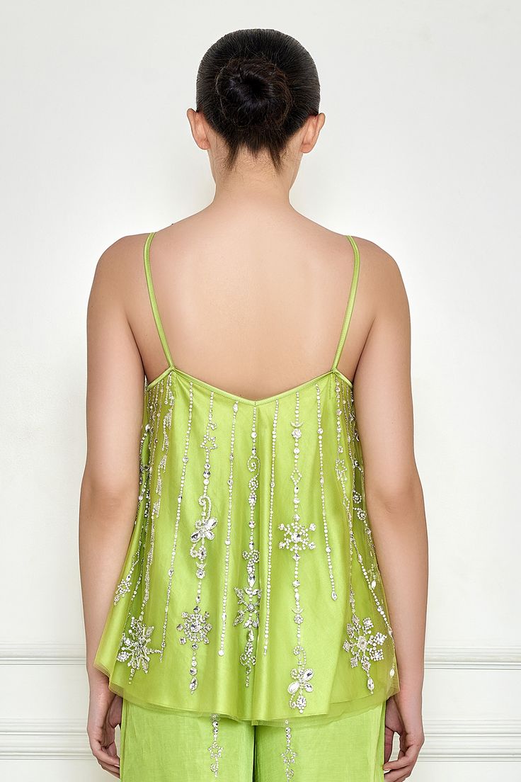 Citrus green spaghetti camisole with floral diamante embroidery.
Components: 1
Pattern: Embroidered
Type Of Work: Diamante
Neckline: Sweetheart
Sleeve Type: Sleeveless
Fabric: Net and Polyester Satin
Color: Green
Other Details: 
Spaghetti strap
Tassel detailing
Attached lining
Note: The pant worn by the model is not for sale
Occasion: Party - Aza Fashions Elegant Green V-neck Camisole, Glamorous Green Tops For Evening, Elegant Green Tank Top, Glamorous Green Top For Evening, Glamorous Green Evening Tops, Spring Sequined Spaghetti Strap Camisole, Sequin Spaghetti Strap Camisole For Spring, Glamorous Sequined Camisole With Spaghetti Straps, Glamorous Spaghetti Strap Camisole For Spring