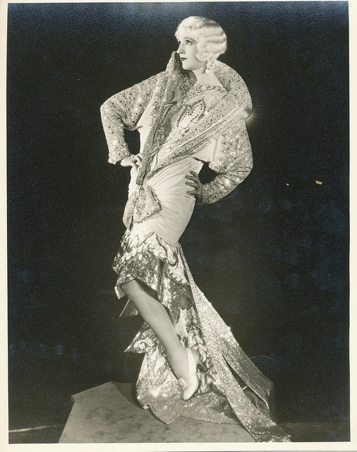 an old fashion photo of a woman in a dress