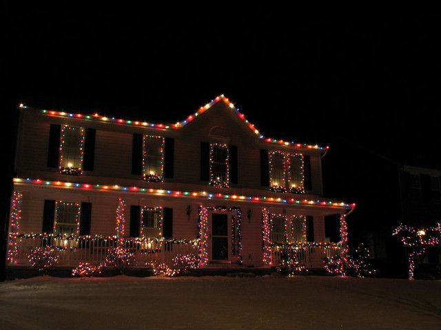 a house covered in christmas lights at night