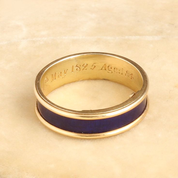 This unassuming gold and blue enamel ring is so much more than meets the eye. Dating to the Regency period, this elegant piece is mourning ring engraved with the following details: "J. D. died 24th May 1825 Aged 84." The interior golds a hinged locket which once would have held plaited hair of the deceased but is now empty. This style of concealed locket mourning ring is quite unusual and very very special. It is a size 6 and cannot be resized. ((details)) Materials: 18k yellow gold, blue enamel Antique Yellow Gold Rings For Commemoration, Formal Engraved Enamel Signet Ring, Yellow Gold Enamel Signet Ring For Anniversary, Anniversary Yellow Gold Enamel Signet Ring, Engraved Enamel Anniversary Ring, Classic Engraved Yellow Gold Enamel Ring, Antique Engraved Yellow Gold Enamel Ring, Victorian Enamel Ring Engraved For Anniversary, Victorian Engraved Enamel Ring For Anniversary