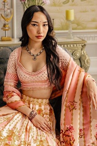 a woman sitting on top of a couch wearing a dress