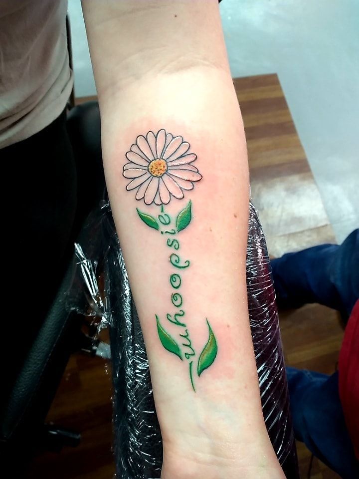 a woman's arm with a flower and the words love is forever on it