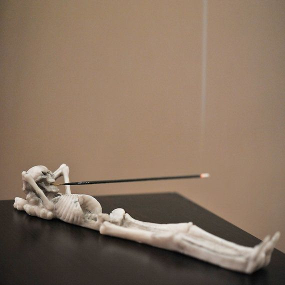 the skeleton is being held by a needle and placed on top of a black table