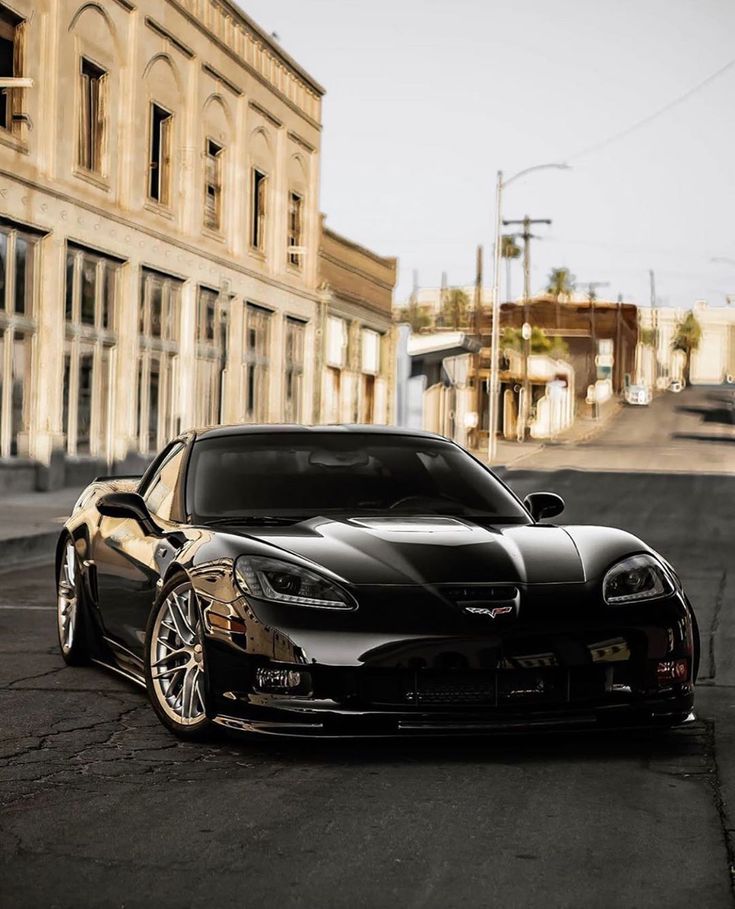 a black sports car parked in front of a building