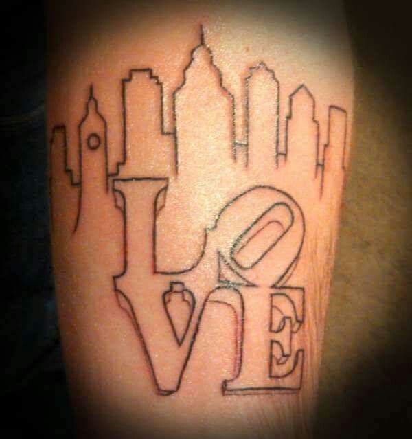 a tattoo with the word love written on it