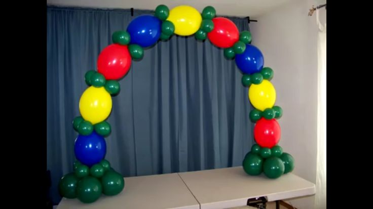 an arch made out of balloons on top of a table