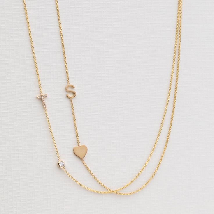 The Monogram Necklace with Heart, a charming fusion of personalization and romance. This delightful necklace features a beautifully crafted monogram of your choice, elegantly accompanied by a dainty heart charm. This enchanting accessory, a symbol of love and individuality, will surely capture hearts wherever you go. This necklace will ship within 1 week Details • Made in Los Angeles • Each necklace is solid 14k gold • 5 mm charms • Our signature .9 mm chain has a lightweight feel • Need help wi Elegant Double Heart Charms Necklace, Elegant Wedding Heart Necklace With Charms, Classic Initial Pendant Charm Necklace For Wedding, Classic Charm Necklace With Initial Pendant For Wedding, Elegant Heart-shaped Charm Necklace, Elegant Heart-shaped Charms Necklace, Elegant Heart Shaped Charms Necklace, White Gold Initials Necklace For Wedding, Elegant Heart-shaped Necklace With Charms