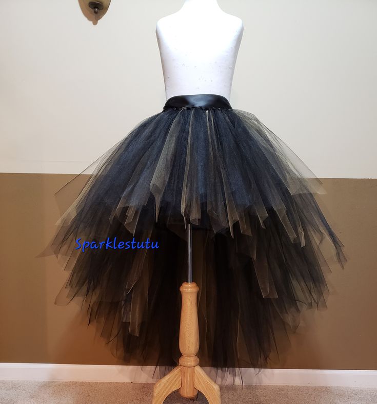 a mannequin wearing a black and white tutu skirt