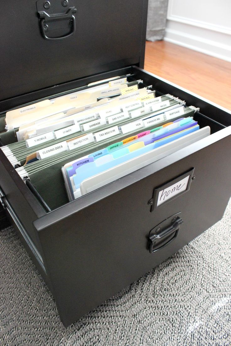 an open file cabinet filled with files on the floor