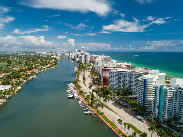 an aerial view of a city and the ocean in miami, florida with boats on the water